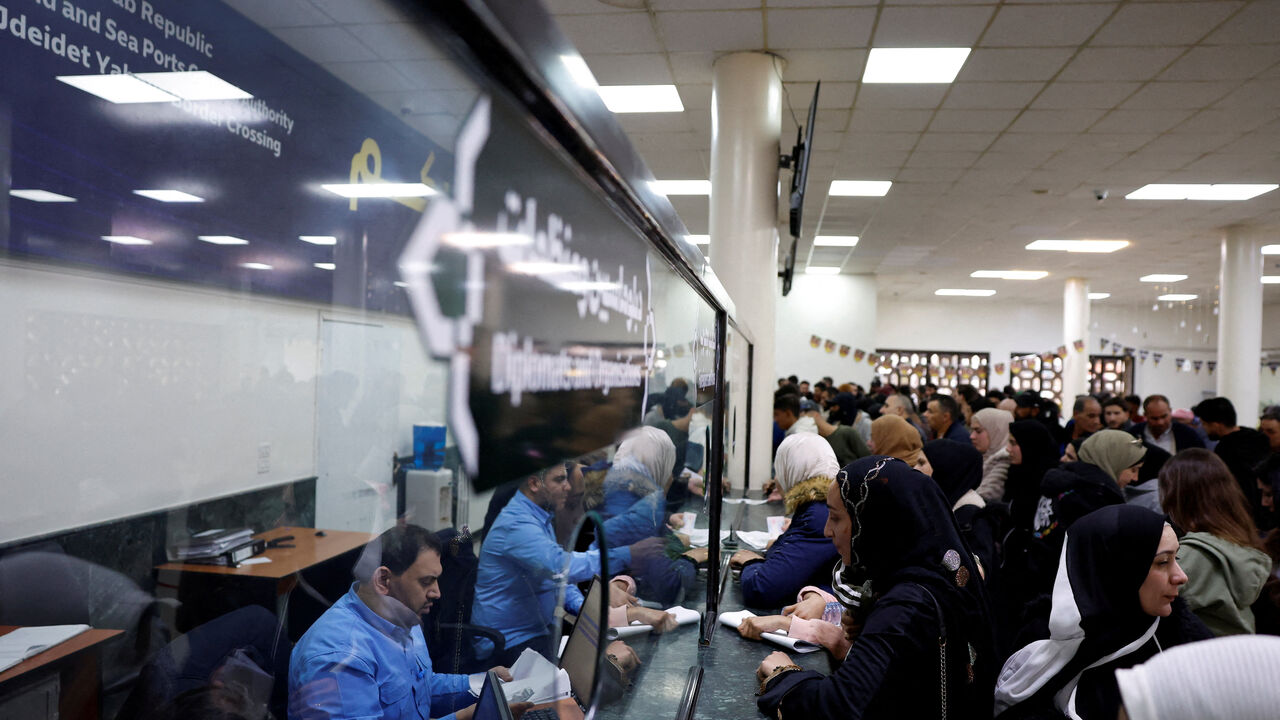 Syrians living in Lebanon wait at the Ministry of Interior Immigration and Passports Department, at the Syrian-Lebanese border, as they return to Syria due to ongoing hostilities between Hezbollah and Israeli forces, amid the U.S.-Israeli conflict with Iran, in Jdaydet Yabous, Syria, March 3, 2026. REUTERS/Yamam Al Shaar
