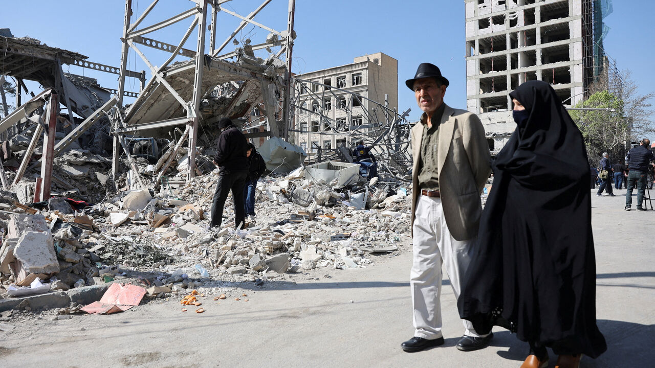 People walk past debris in the aftermath of a strike on a police station, amid the U.S.-Israeli conflict with Iran, in Tehran, Iran, March 4, 2026. Majid Asgaripour/WANA (West Asia News Agency) via REUTERS