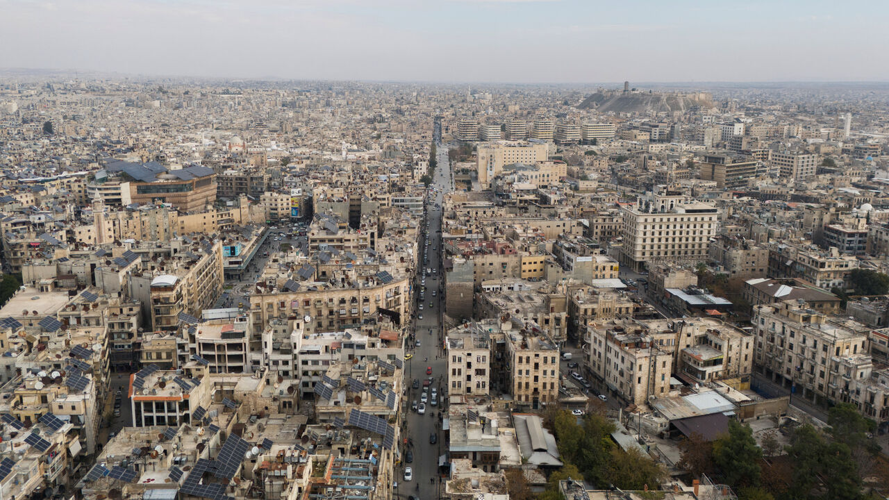 FILE PHOTO: A drone view shows buildings and the ancient citadel, in Aleppo, Syria, December 4, 2024. REUTERS/Karam al-Masri