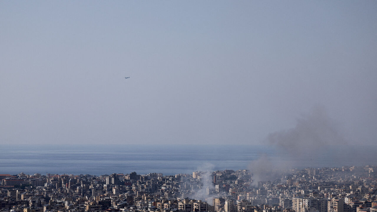 FILE PHOTO: Smoke rises after an Israeli airstrike as a plane takes off from Rafik Hariri Airport, following an escalation between Hezbollah and Israel amid the U.S.-Israeli conflict with Iran, in Beirut, Lebanon March 3, 2026. REUTERS/Khalil Ashawi/File Photo