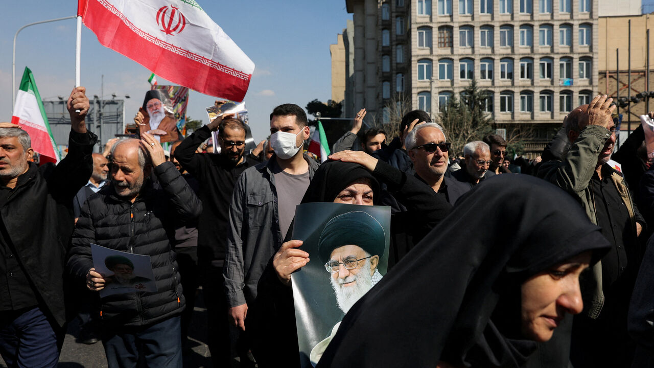 A demonstrator holds an image of Iran's late Supreme Leader Ayatollah Ali Khamenei, after he was killed in Israeli and U.S. strikes on Saturday, during an anti-Israeli and U.S. rally after Friday prayer, amid the U.S.-Israeli conflict with Iran, in Tehran, Iran, March 6, 2026. Majid Asgaripour/WANA (West Asia News Agency) via REUTERS