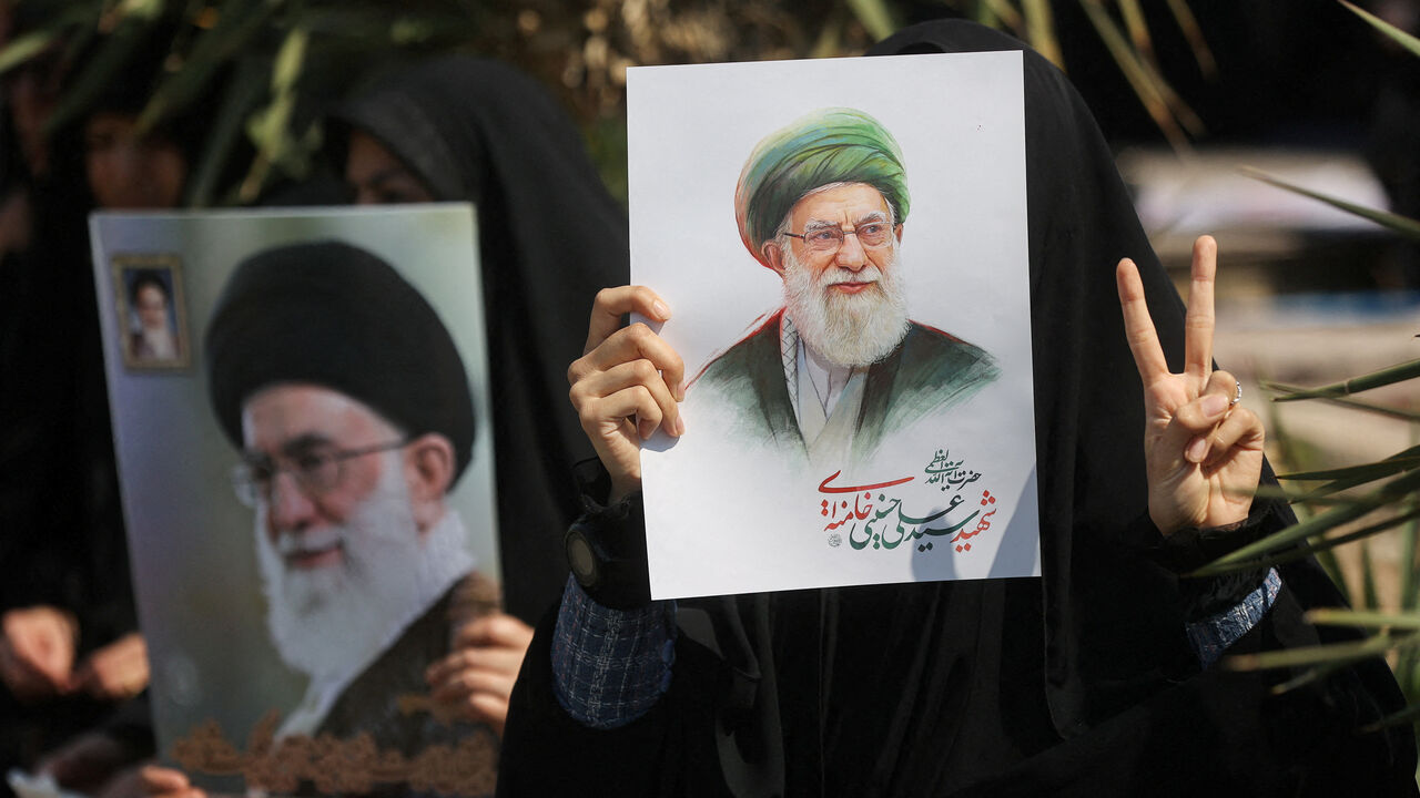 FILE PHOTO: A woman gestures while holding an image of Iran's late Supreme Leader Ayatollah Ali Khamenei, on the day of an anti-Israeli and U.S. rally, amid the U.S.-Israeli conflict with Iran, in Tehran, Iran, March 6, 2026. Majid Asgaripour/WANA (West Asia News Agency) via REUTERS/File Photo