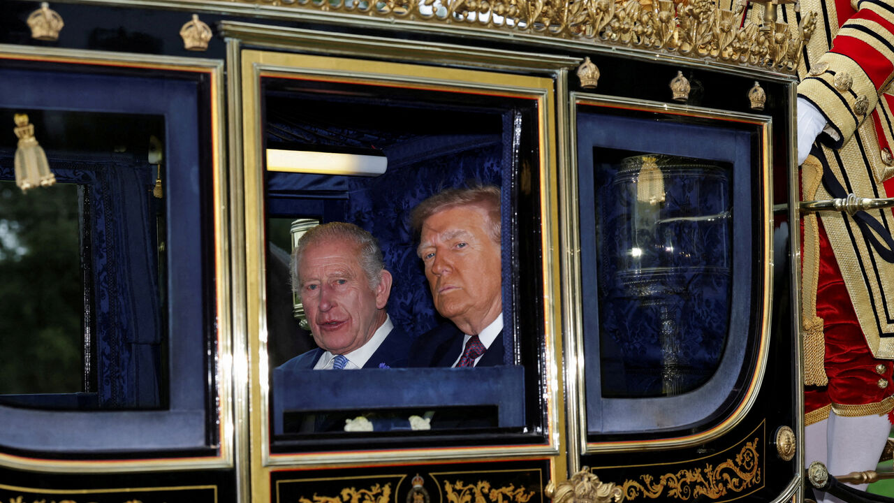 FILE PHOTO: Britain's King Charles and U.S. President Donald Trump sit in a carriage during a procession through Windsor Castle, in Windsor, Britain, September 17, 2025. REUTERS/Toby Melville/Pool/File Photo