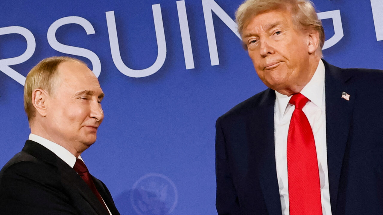 FILE PHOTO: U.S. President Donald Trump looks on next to Russian President Vladimir Putin during a press conference following their meeting to negotiate an end to the war in Ukraine, at Joint Base Elmendorf-Richardson, in Anchorage, Alaska, U.S., August 15, 2025. REUTERS/Kevin Lamarque /File Photo