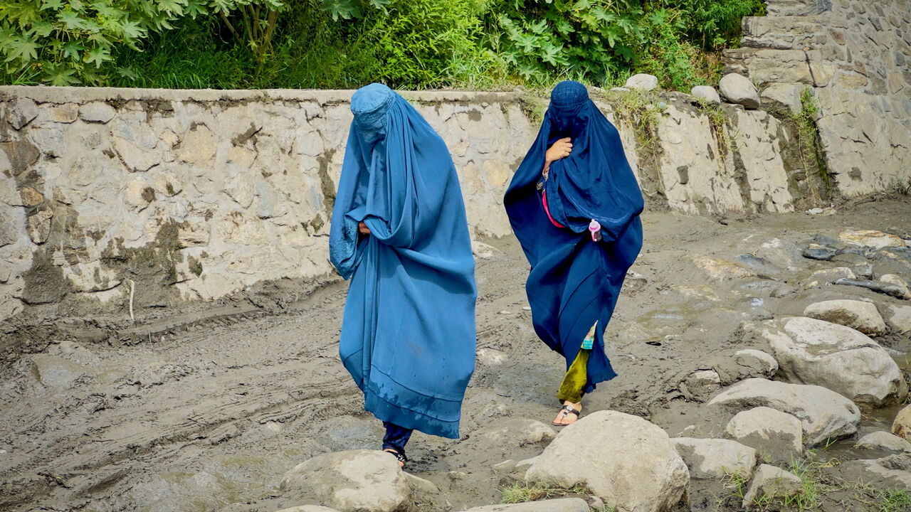 FILE PHOTO: Afghan women in burqa walk towards a safer place after their house was damaged following a deadly magnitude 6 earthquake that struck Afghanistan on Sunday, at Lulam village, in Nurgal district, Kunar province, Afghanistan, September 3, 2025. REUTERS/Sayed Hassib/File Photo/File Photo