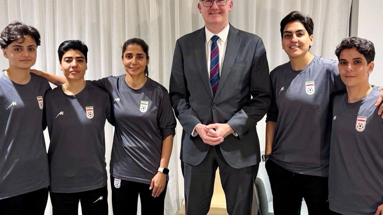 Australia’s Home Affairs Minister Tony Burke poses with Fatemeh Pasandideh, Mona Hamoudi, Atefeh Ramezanizadeh, Zahra Ghanbari and Zahra Sarbali, the five women from the Iranian women’s soccer team who were granted humanitarian visas, in Queensland, Australia, March 9, 2026. @Tony_Burke on X/Handout via REUTERS