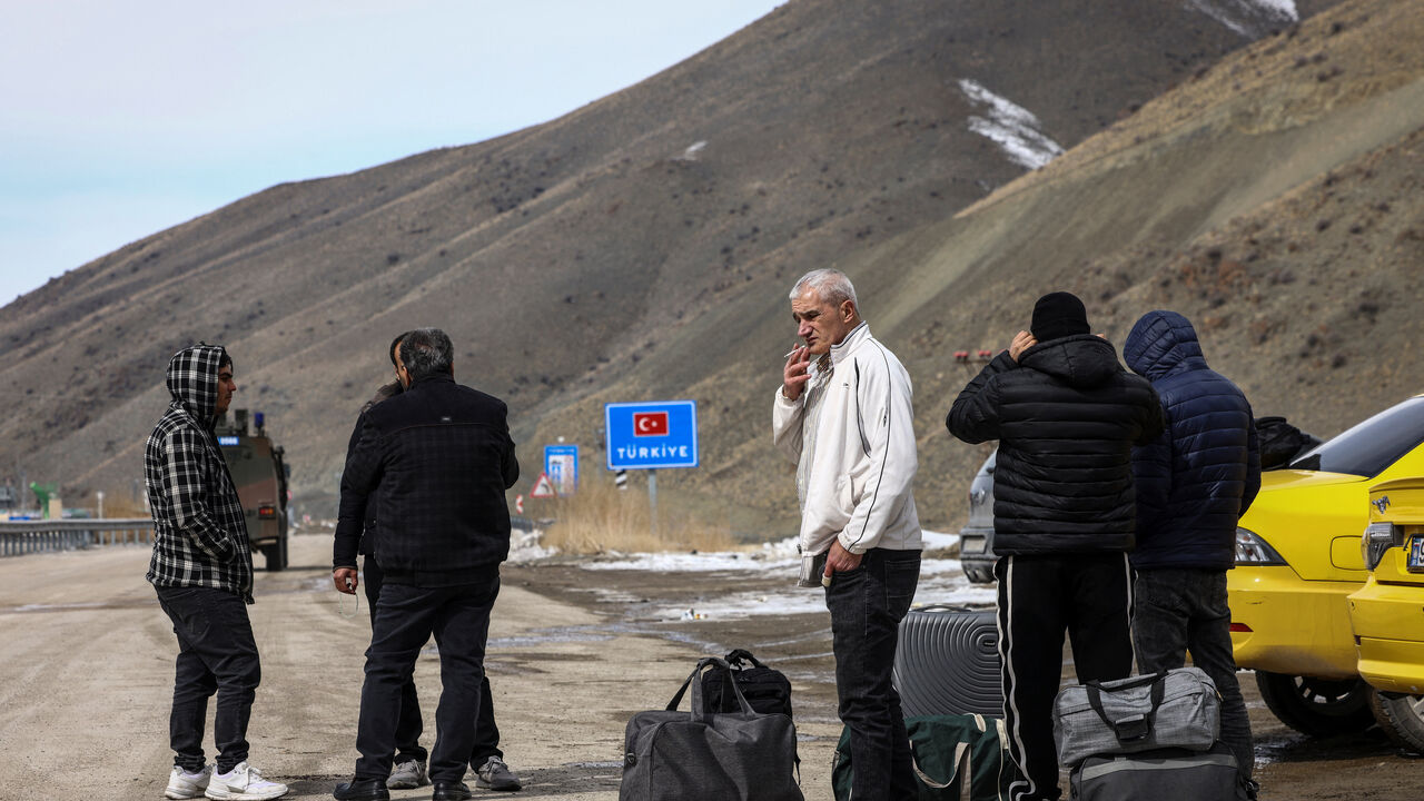 People who have arrived in Turkey from Iran stand after crossing into Turkey, in Van province, Turkey, March 6, 2026. REUTERS/Dilara Senkaya
