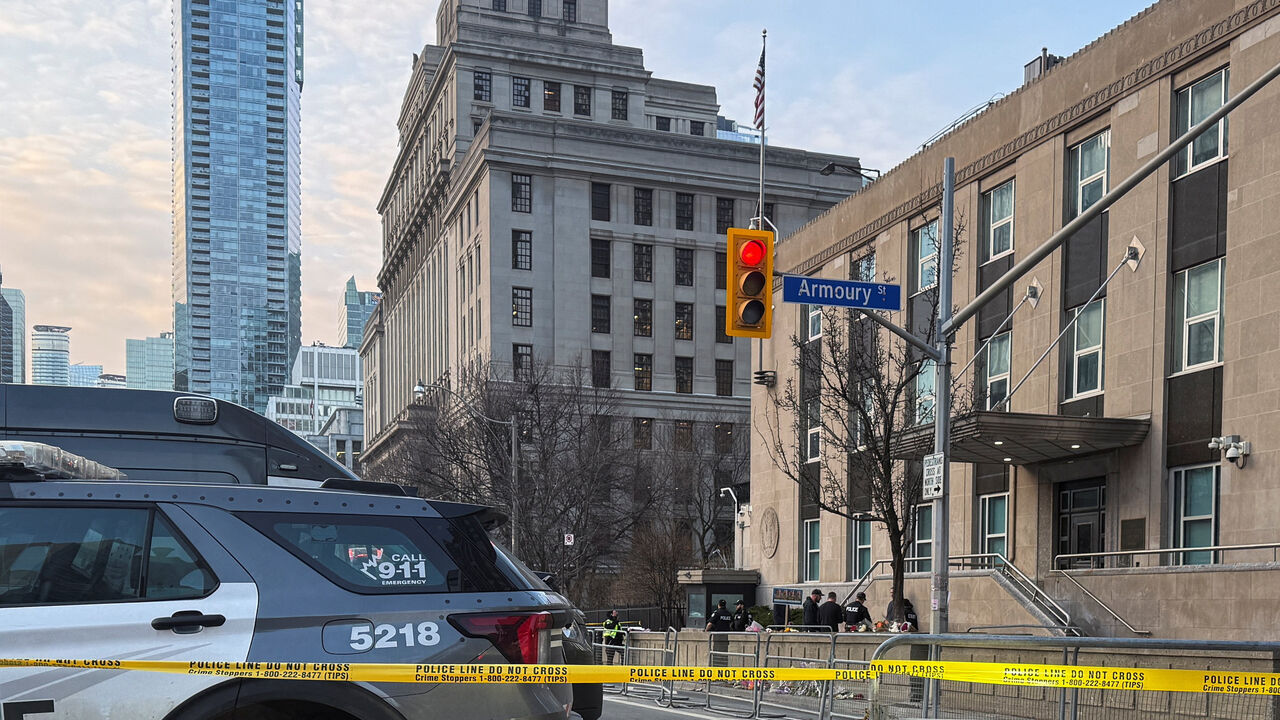 Law enforcement personnel survey the scene outside the U.S. Consulate after shots were fired, in Toronto, Ontario, Canada, March 10, 2026. Picture taken with a mobile phone. REUTERS/Kyaw Soe Oo