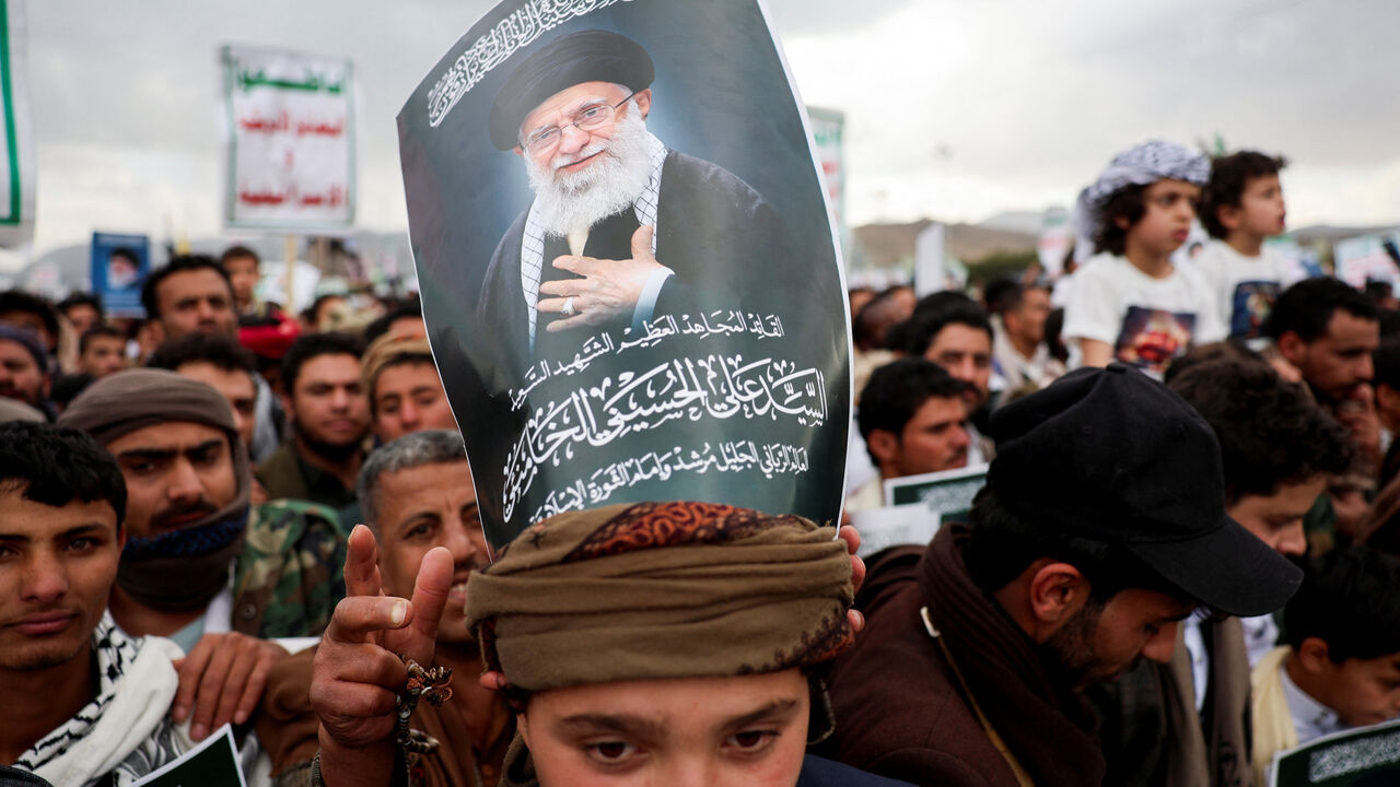 A protester with a poster on his head featuring a picture of late Iran's Supreme Leader Ayatollah Ali Khamenei joins a demonstration with Houthi supporters in solidarity with Iran and Lebanon, amid the U.S.-Israeli conflict with Iran, in Sanaa, Yemen March 6, 2026. REUTERS/Khaled Abdullah