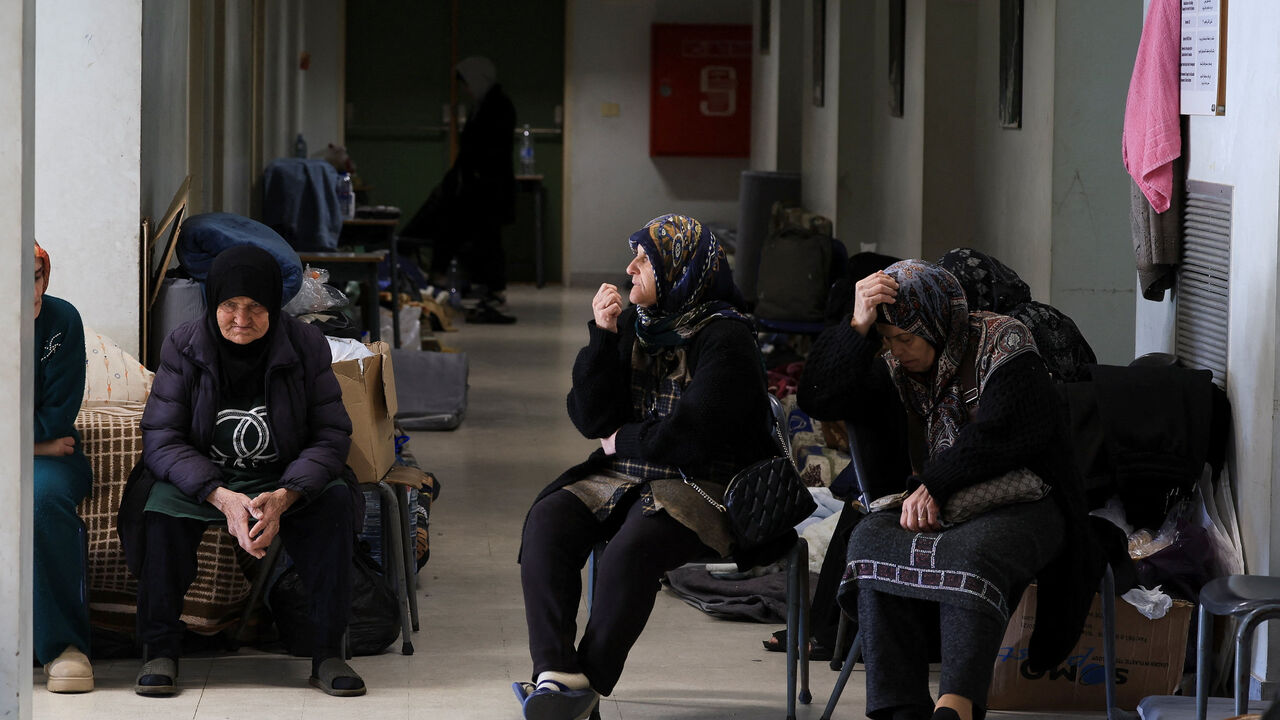 Women sit in a school turned shelter for people displaced from Beirut's southern suburbs and southern Lebanon, following an escalation between Hezbollah and Israel amid the U.S.-Israeli conflict with Iran, in Beirut, Lebanon, March 11, 2026. REUTERS/Mohamed Azakir