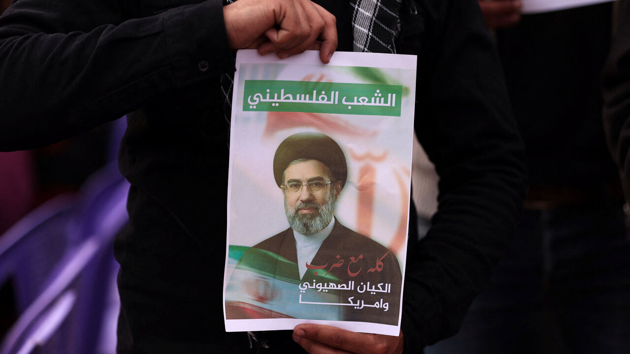 A Palestinian holds an image depicting Iran's new Supreme Leader Mojtaba Khamenei, as they take part in a rally on the al-Quds Day (Jerusalem Day), in Gaza City, March 13, 2026. REUTERS/Dawoud Abu Alkas