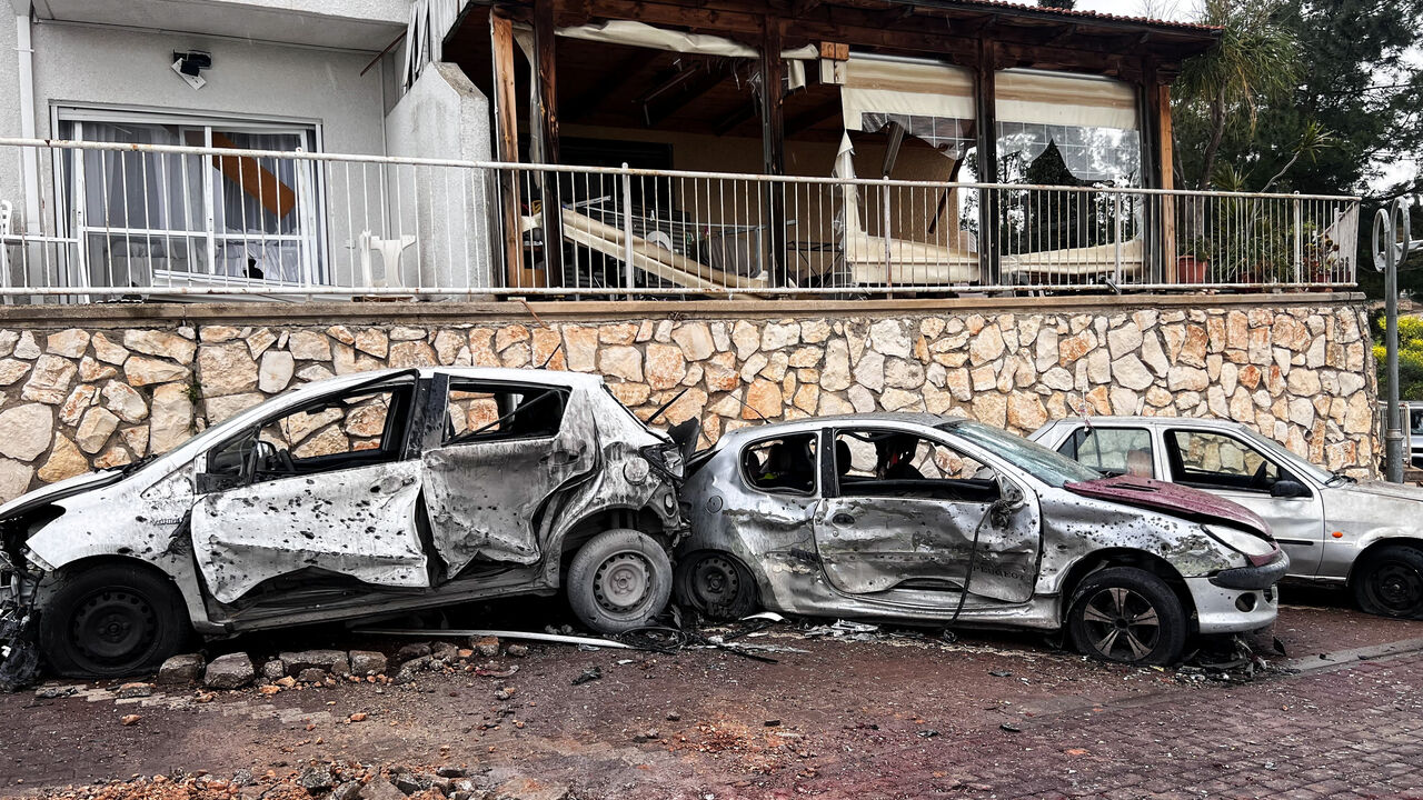 Damaged vehicles and buildings, after a projectile was launched towards Israel from the Iran-backed Hezbollah in Lebanon, following an escalation between Hezbollah and Israel amid the U.S.-Israeli conflict with Iran, in northern Israel, March 14, 2026. REUTERS/Avi Ohayon