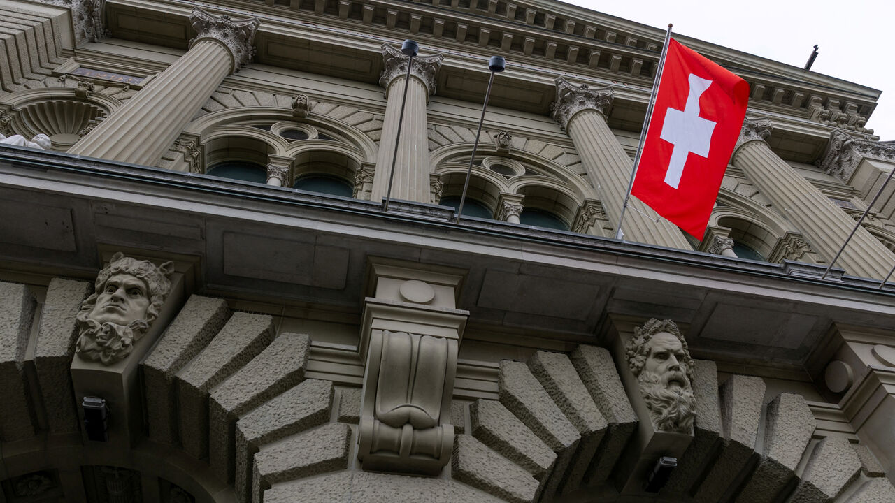 FILE PHOTO: A Swiss flag hangs at the Swiss Parliament building (Bundeshaus) in Bern, Switzerland, March 12, 2025. REUTERS/Denis Balibouse/File Photo