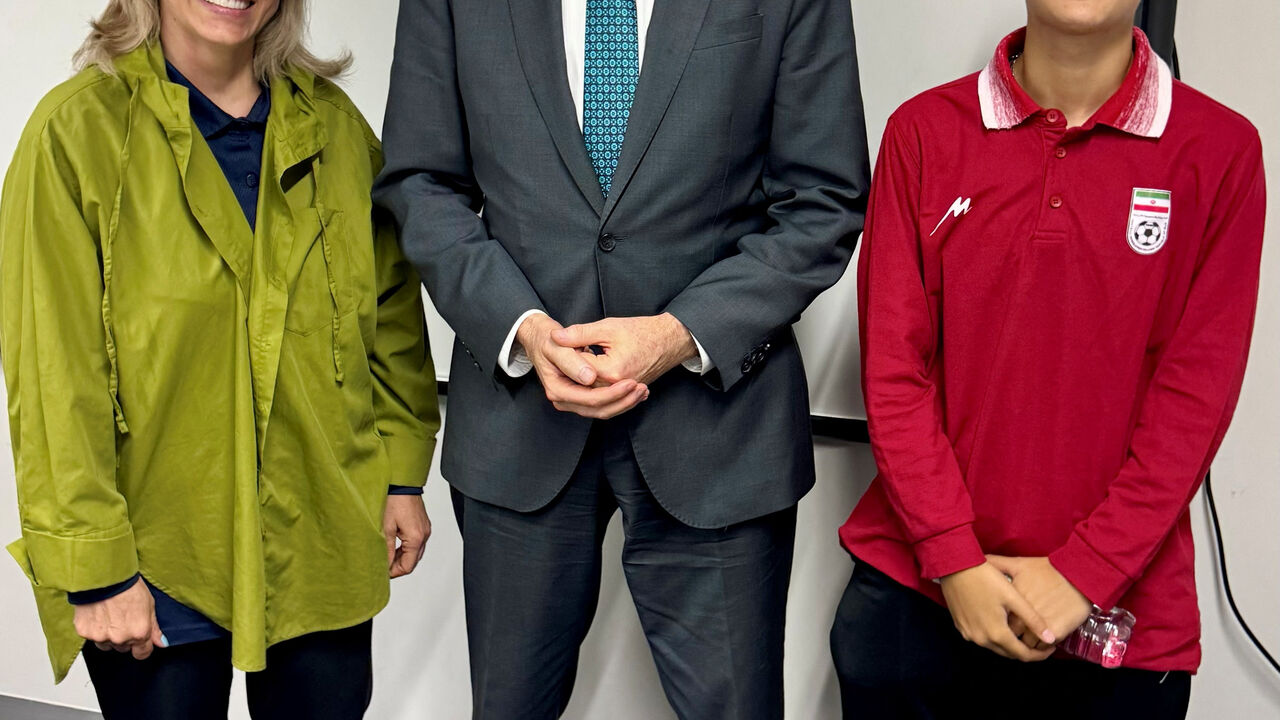Australia's Home Affairs Minister Tony Burke poses with Iranian women's soccer team support worker Zahra Soltan Meshkeh Kar and team player Mohaddeseh Zolfi, who were granted asylum overnight, in Australia, March 10, 2026. Picture taken with a mobile phone. @Tony_Burke on X/Handout via REUTERS