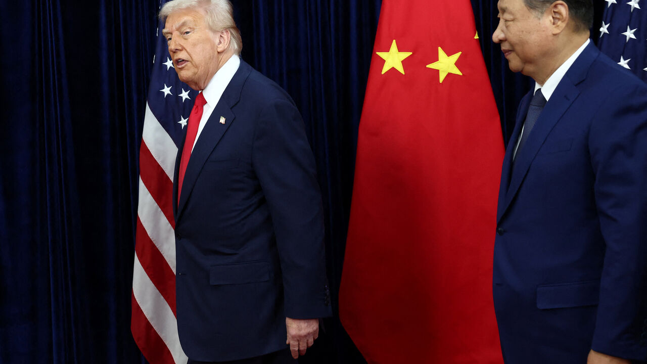 U.S. President Donald Trump walks with Chinese President Xi Jinping as they hold a bilateral meeting at Gimhae International Airport, on the sidelines of the Asia-Pacific Economic Cooperation (APEC) summit, in Busan, South Korea, October 30, 2025. REUTERS/Evelyn Hockstein