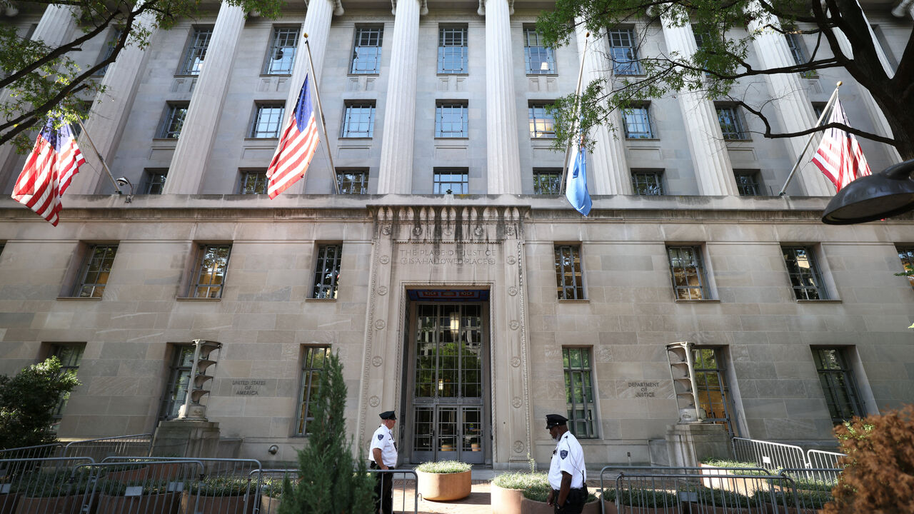 Officers keep watch outside the Department of Justice building in Washington, D.C., U.S., September 23, 2025. REUTERS/Kevin Lamarque