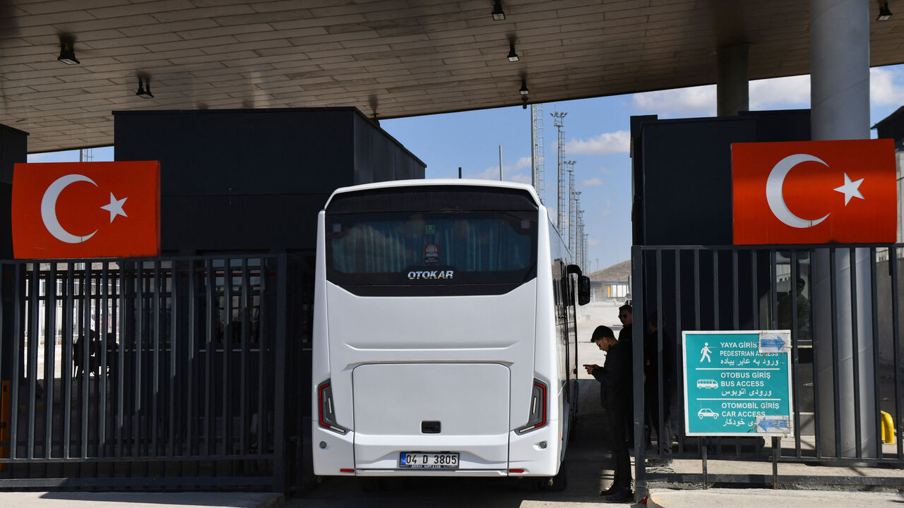 A bus carrying members of the Iranian women's national soccer team arrives at the Gurbulak Border Gate, a crossing point between Turkey and Iran, as they travel to their home country after five players withdrew the asylum claims they had lodged in Australia over safety concerns about returning due to not singing the national anthem at a women's Asian Cup match earlier this month, in the eastern Agri province, Turkey, March 18, 2026. REUTERS/Ali Ihsan Ozturk