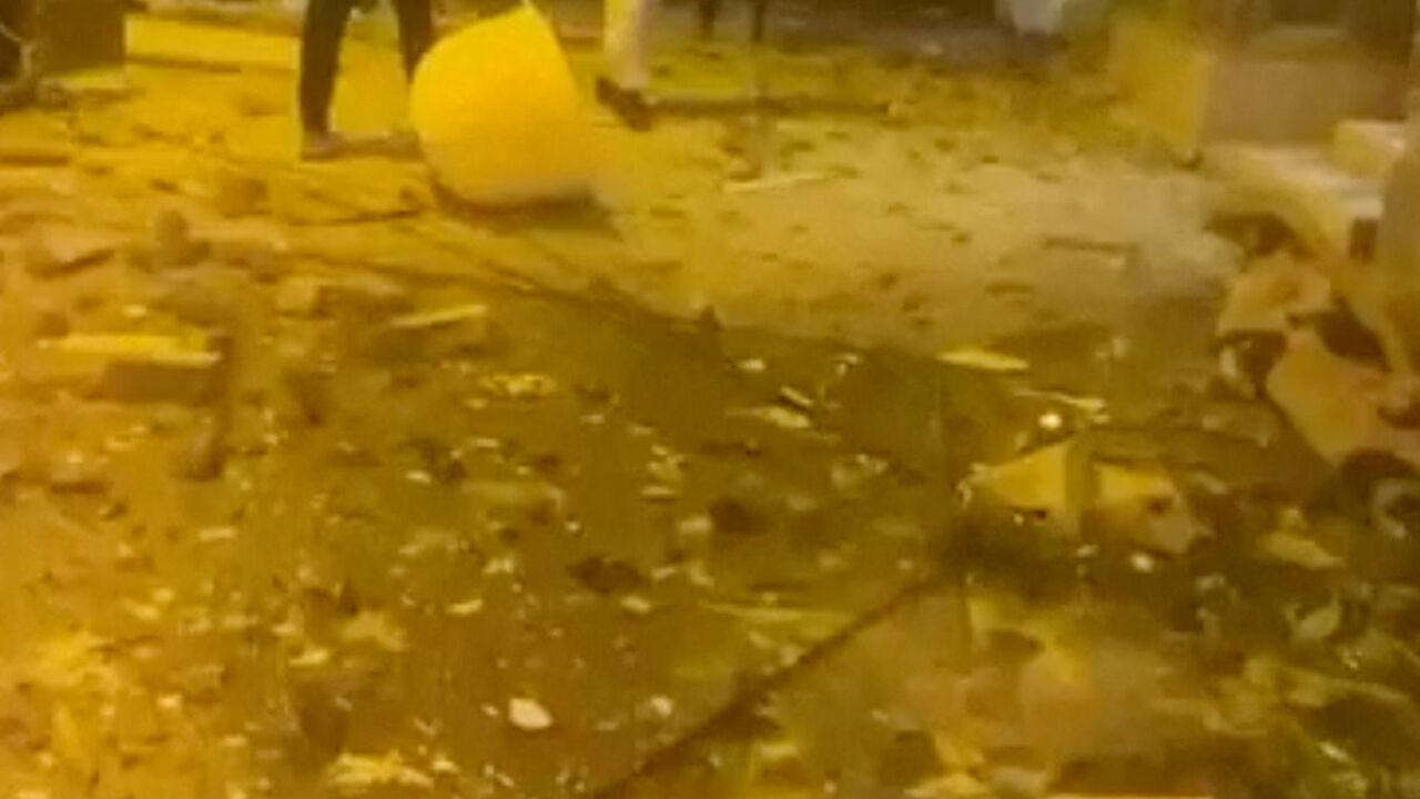 Debris lies on the street following reported Iranian drone strikes, amid the U.S.-Israeli conflict with Iran, in Sitra, Bahrain, March 9, 2026 in this screengrab taken from a social media video. SOCIAL MEDIA/via REUTERS
