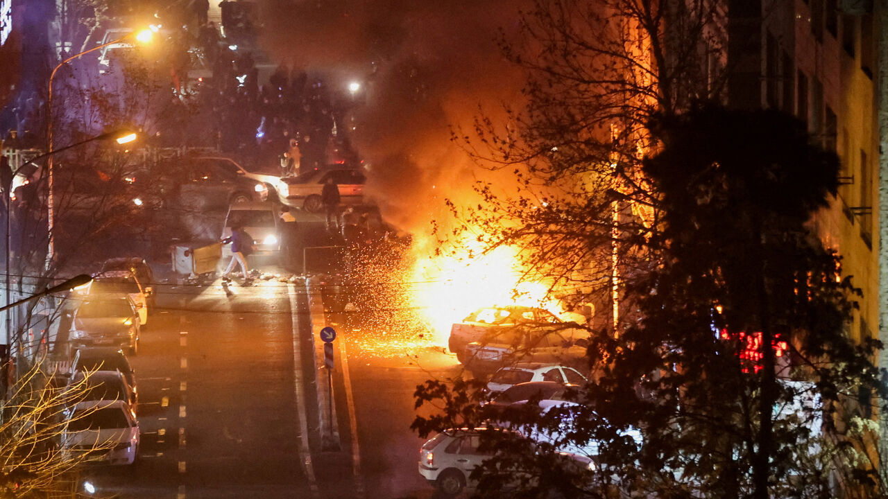 FILE PHOTO: Cars burn in a street during a protest over the collapse of the currency's value, in Tehran, Iran, January 8, 2026. Stringer/WANA (West Asia News Agency) via REUTERS/File Photo
