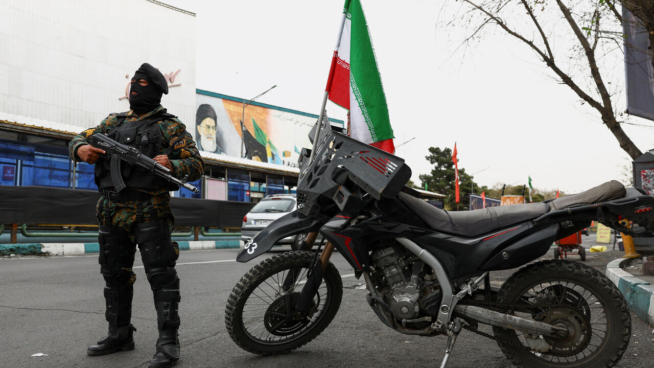 A member of a police force stands guard on a street, amid the U.S.-Israeli conflict with Iran, in Tehran, Iran, March 23, 2026. Majid Asgaripour/WANA (West Asia News Agency) via REUTERS