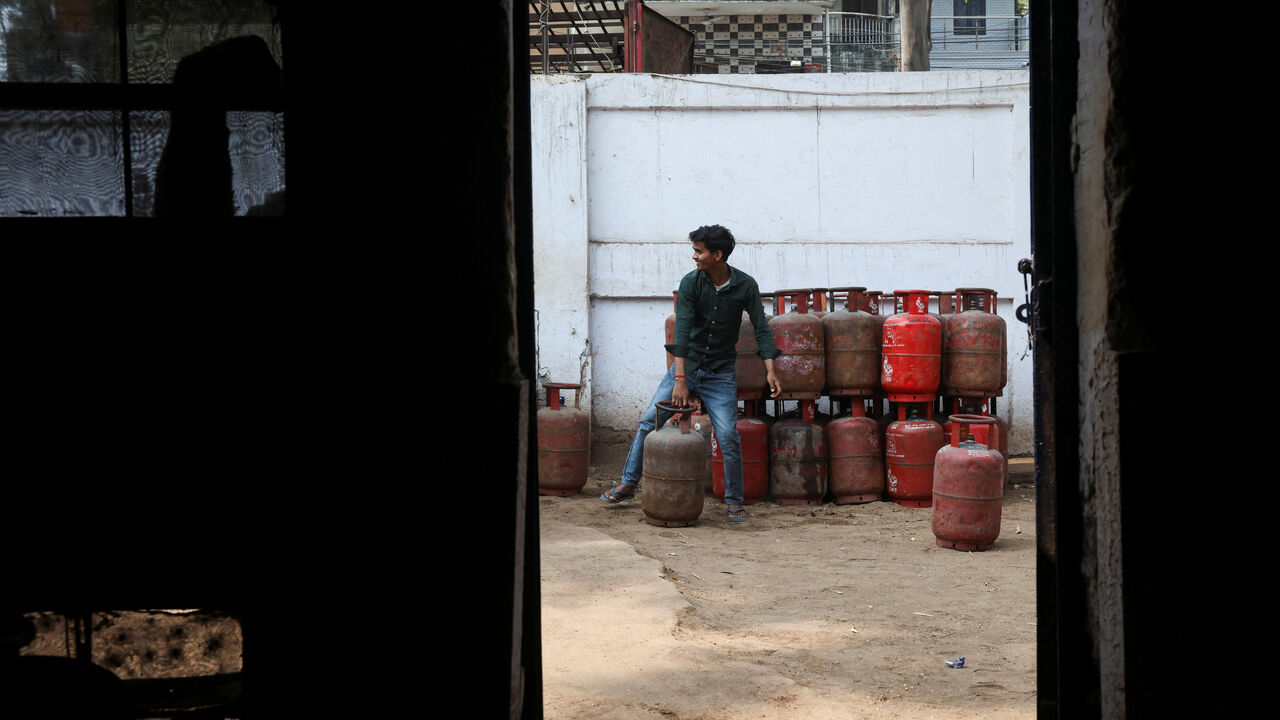 FILE PHOTO: A worker moves an LPG cylinder at a godown, amid supply disruptions following the U.S.-Israeli conflict with Iran, in New Delhi, India, March 10, 2026. REUTERS/Bhawika Chhabra/File Photo