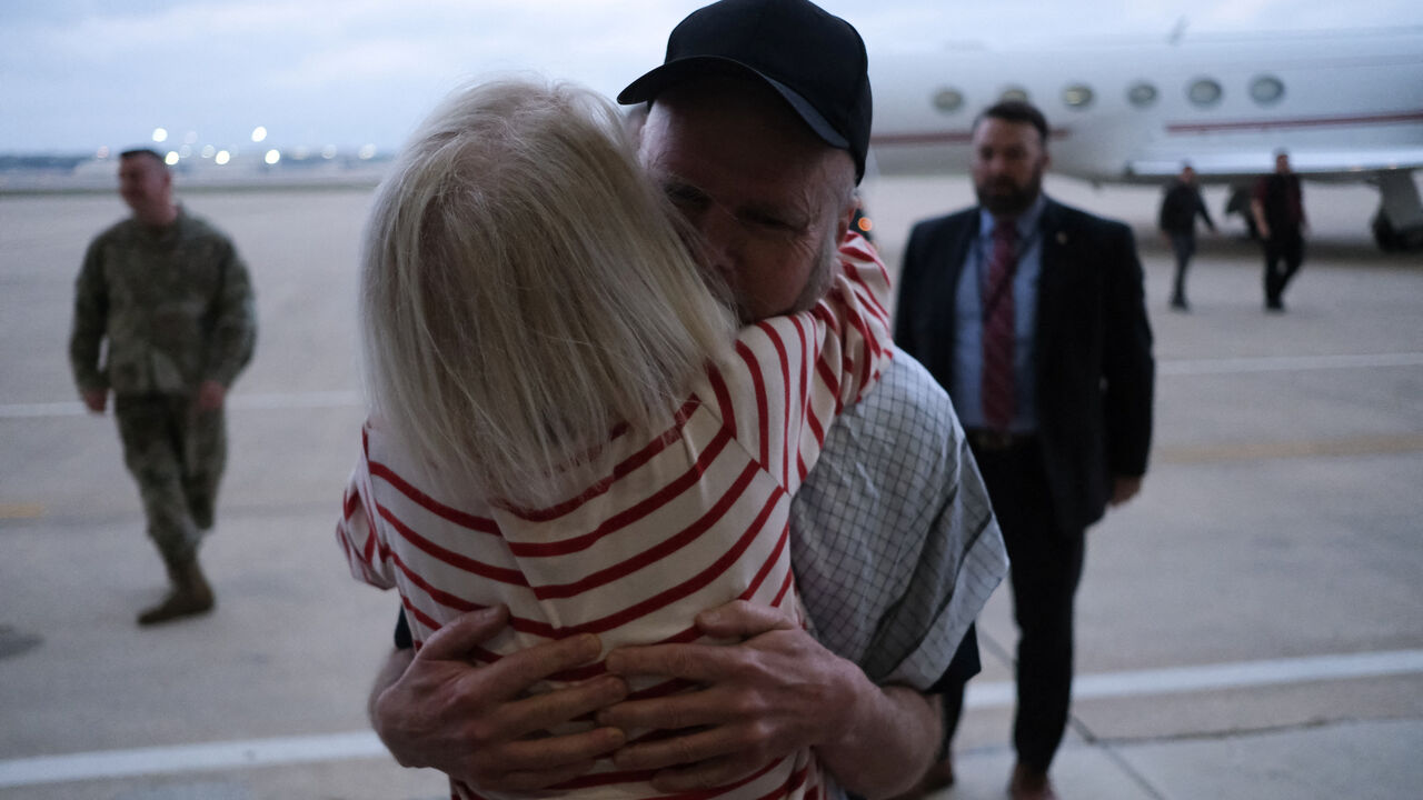 American Dennis Coyle, who was detained by the Afghan Taliban government for more than year, is greeted as he arrives at Joint Base San Antonio in San Antonio, Texas, U.S., March 25, 2026. REUTERS/Joel Angel Juarez