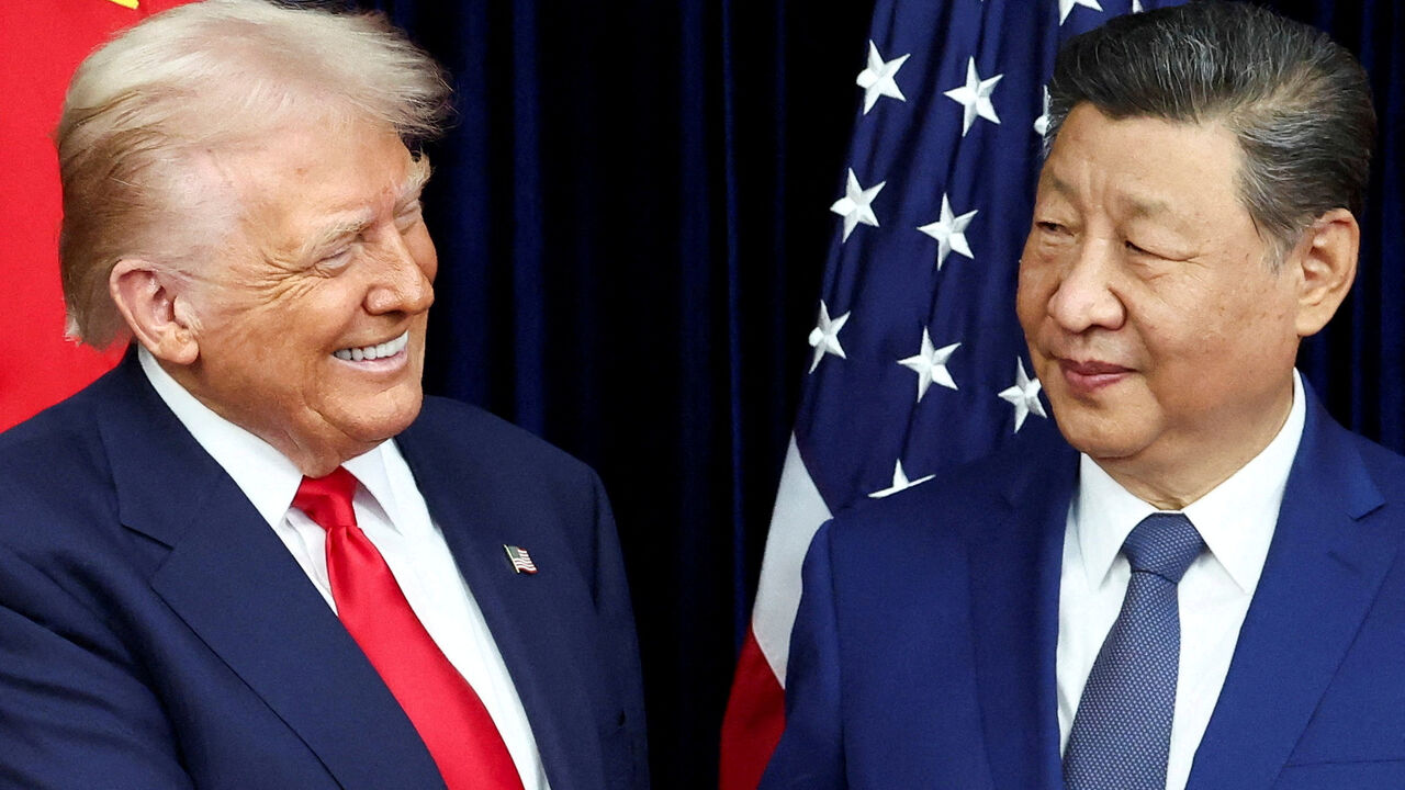 FILE PHOTO: U.S. President Donald Trump and Chinese President Xi Jinping react as they hold a bilateral meeting at Gimhae International Airport, on the sidelines of the Asia-Pacific Economic Cooperation (APEC) summit, in Busan, South Korea, October 30, 2025. REUTERS/Evelyn Hockstein/File Photo