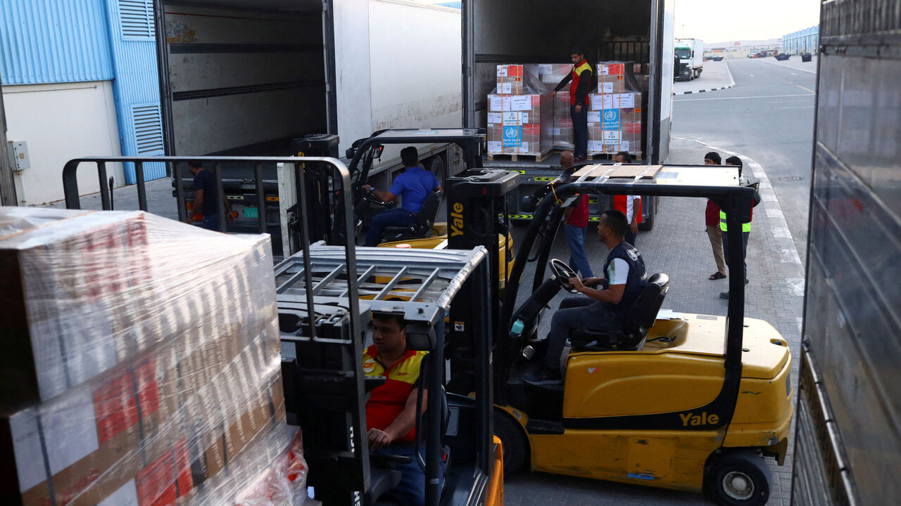 A World Health Organization (WHO) employees load trucks with humanitarian relief boxes ahead of flights sponsored by the International Humanitarian City (IHC) to Turkey and Syria which were devastated by an earthquake, in Dubai, United Arab Emirates, February 7, 2023. REUTERS/Amr Alfiky