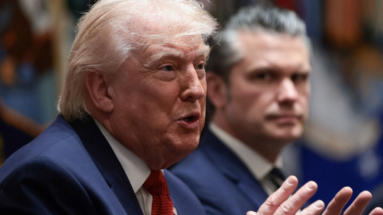 U.S. President Donald Trump speaks next to Defense Secretary Pete Hegseth during a cabinet meeting at the White House in Washington, D.C., U.S., March 26, 2026. REUTERS/Evelyn Hockstein