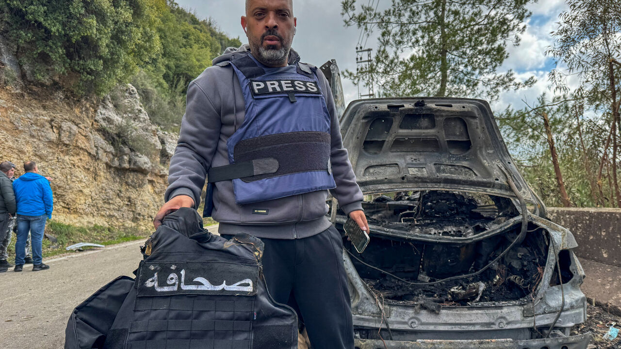 Al Mayadeen journalist Jamal Al-Gharabi holds the press vest of one of the two Lebanese journalists who were killed by a targeted Israeli strike, amid escalating hostilities between Israel and Hezbollah, as the U.S.-Israeli conflict with Iran continues, in Jezzine, in southern Lebanon, March 28, 2026. The sign on the vest reads "Press". Picture taken with a mobile phone. REUTERS/Ali Hankir