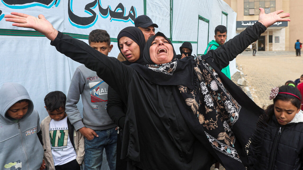 A woman mourns during the funeral of six Palestinians, including three policemen, killed in Israeli strikes, according to medics, at Nasser Hospital in Khan Younis in the southern Gaza Strip, March 29, 2026. REUTERS/Ramadan Abed