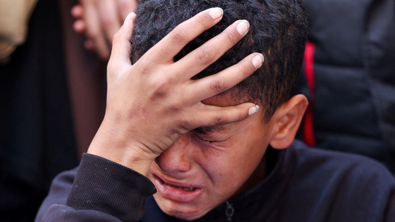 A boy reacts during the funeral of Palestinians who, according to medics, were killed in an Israeli strike, in Gaza City, March 30, 2026. REUTERS/Dawoud Abu Alkas
