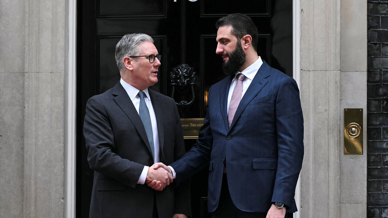 Syria's President Ahmed al-Sharaa is welcomed by Britain's Prime Minister Keir Starmer ahead of their meeting at 10 Downing Street in central London, Britain, March 31, 2026.     JUSTIN TALLIS/Pool via REUTERS