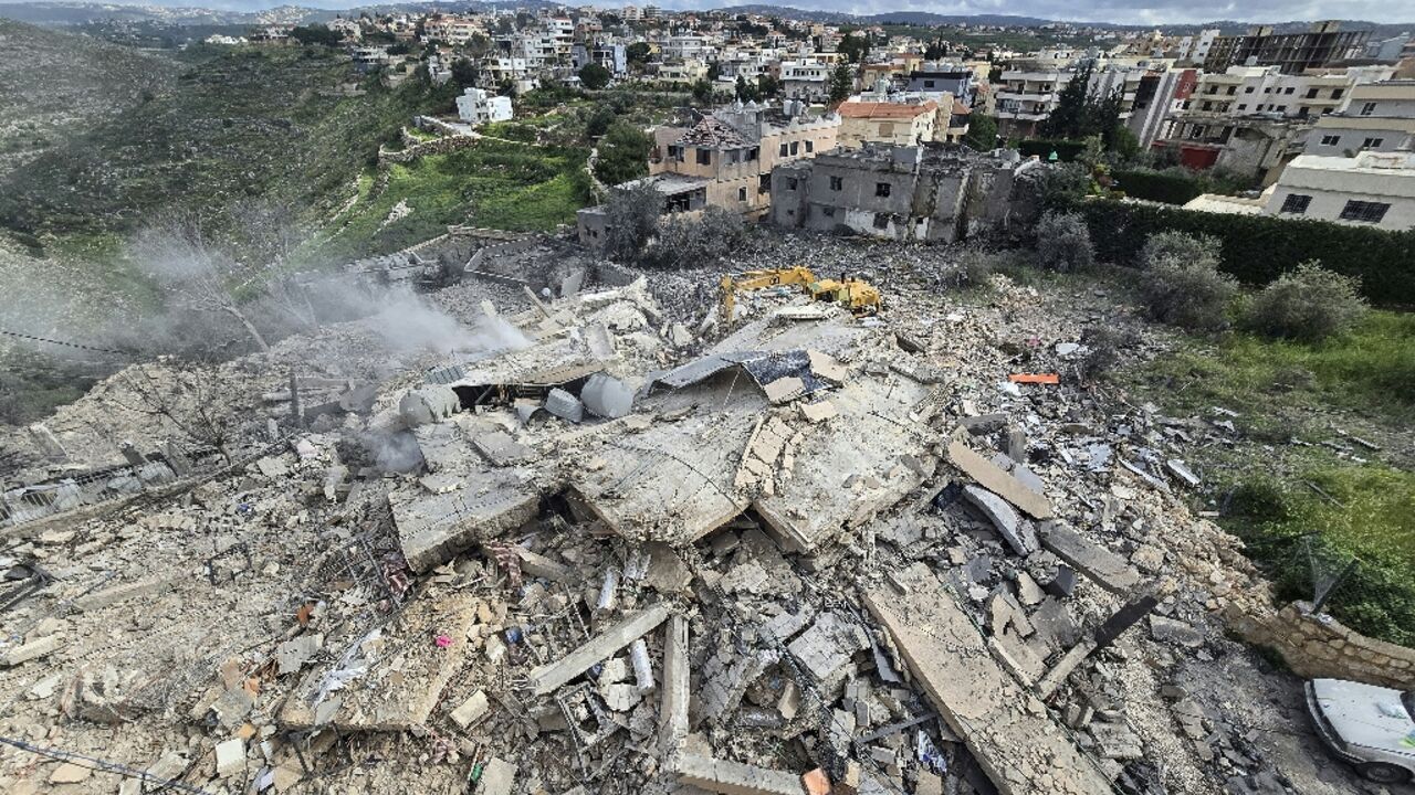 First responders work on the rubble of a building targeted by an Israeli airstrike in the southern Lebanese village of Hanouiyeh, east of Tyre
