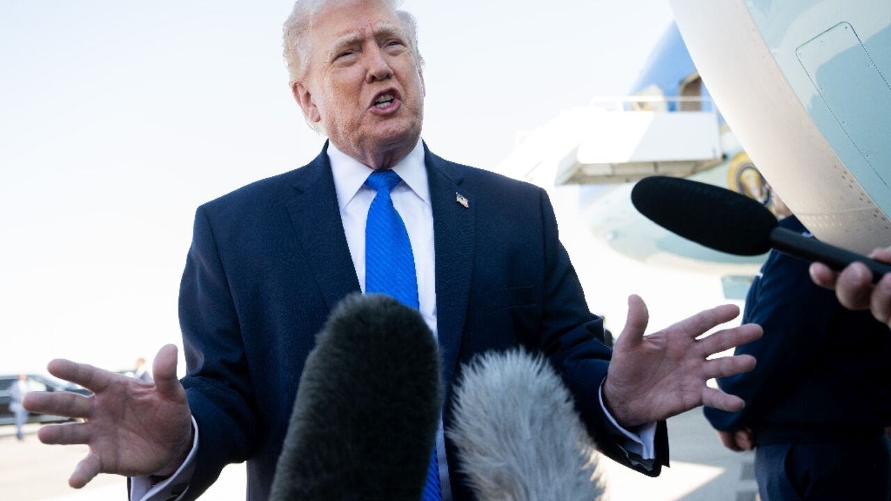 US President Donald Trump speaks to reporters before boarding Air Force One in Florida