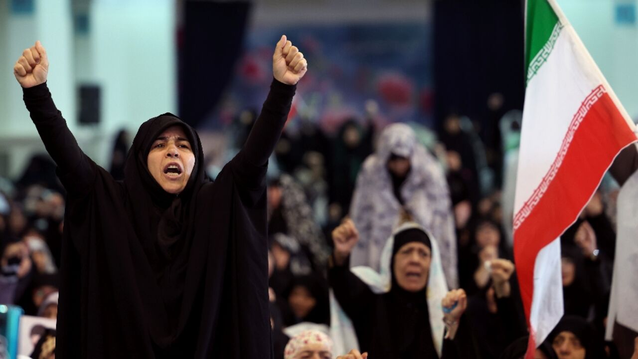 Iranian Shia women shout slogans during Eid al-Fitr prayers, marking the end of the Muslim holy month of Ramadan, despite the threat of intensified US and Israeli air strikes
