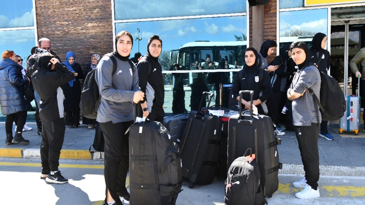 Members of Iran's women's football team at Igdir airport in Turkey, waiting for a bus to take them to the Iranian border 
