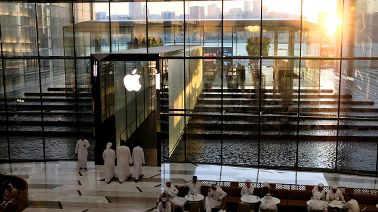People sit in a cafe outside the Apple Store in Dubai on May 8, 2025. (Photo by Giuseppe CACACE / AFP) (Photo by GIUSEPPE CACACE/AFP via Getty Images)
