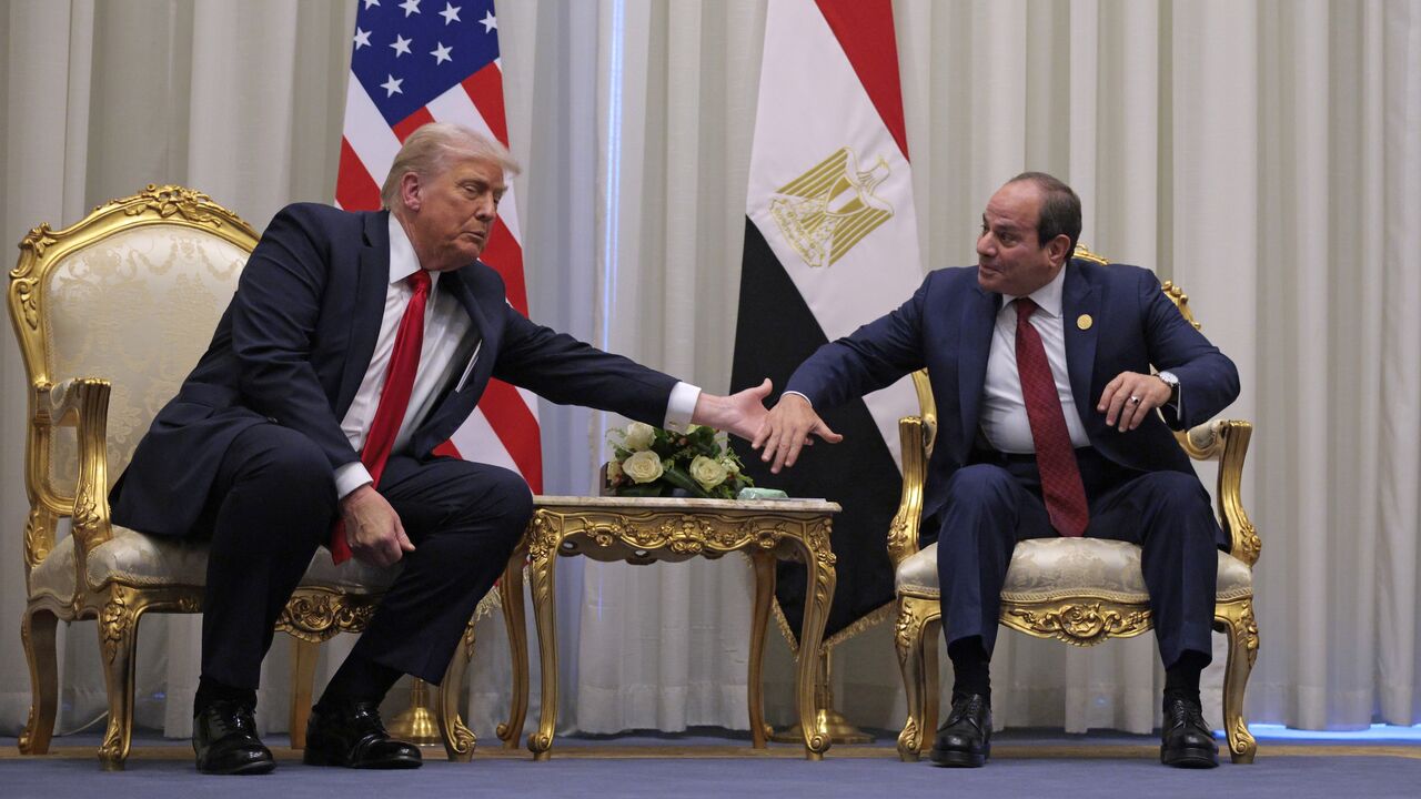 US President Donald Trump and President of Egypt Abdel Fattah El-Sisi clasp hands as they speak to the press before their meeting on Oct. 13, 2025, in Sharm el-Sheikh, Egypt. 