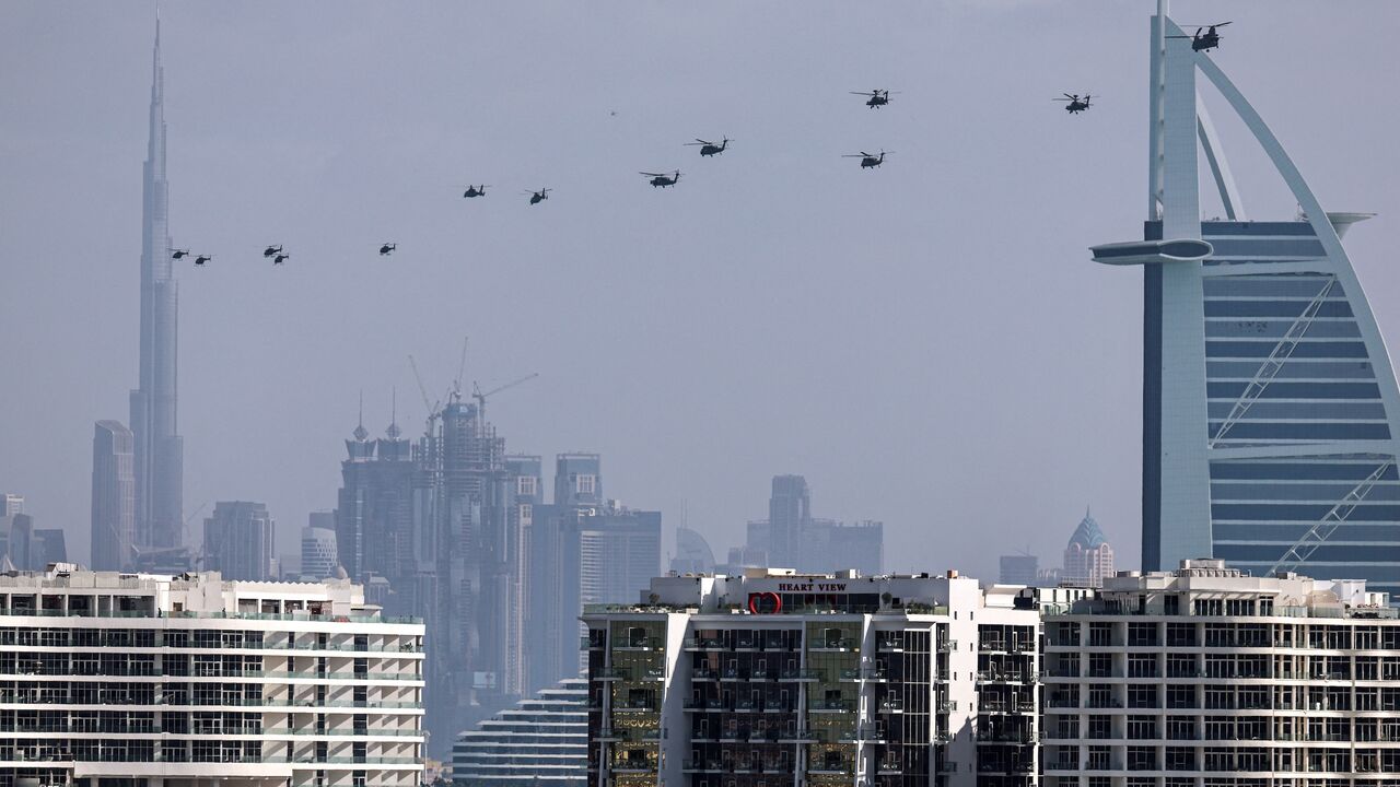 United Arab Emirates army helicopters fly from the Burj al Arab hotel (R) toward Burj Khalifa, Dubai, Jan. 16, 2026.