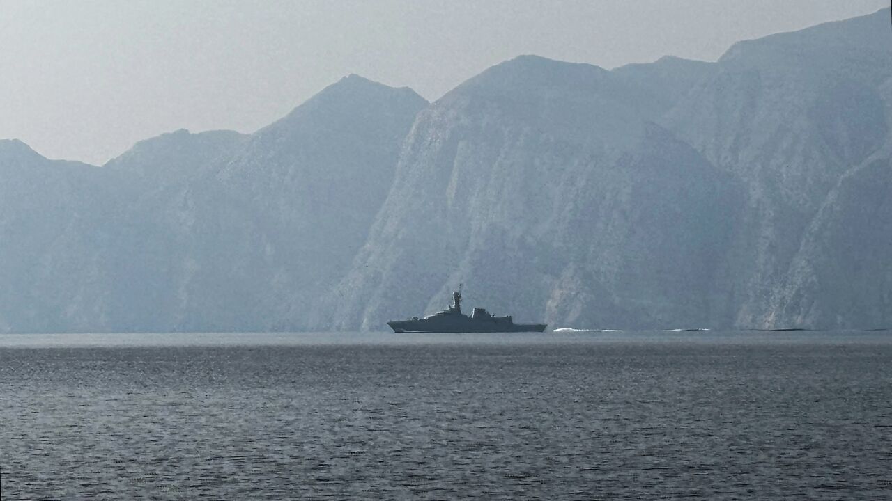 A navy vessel is seen sailing in the Strait of Hormuz, a vital waterway through which much of the world's oil and gas passes, on March 1, 2026. 