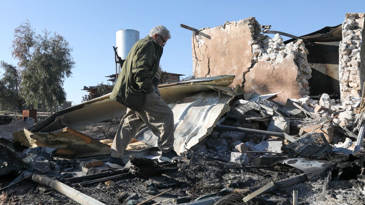 An Iranian Kurdish peshmerga member of the Kurdistan Democratic Party of Iran inspects the damage sustained at the Azadi Camp following an Iranian cross-border attack in the town of Koye, east of Erbil district, on March 3, 2026. 
