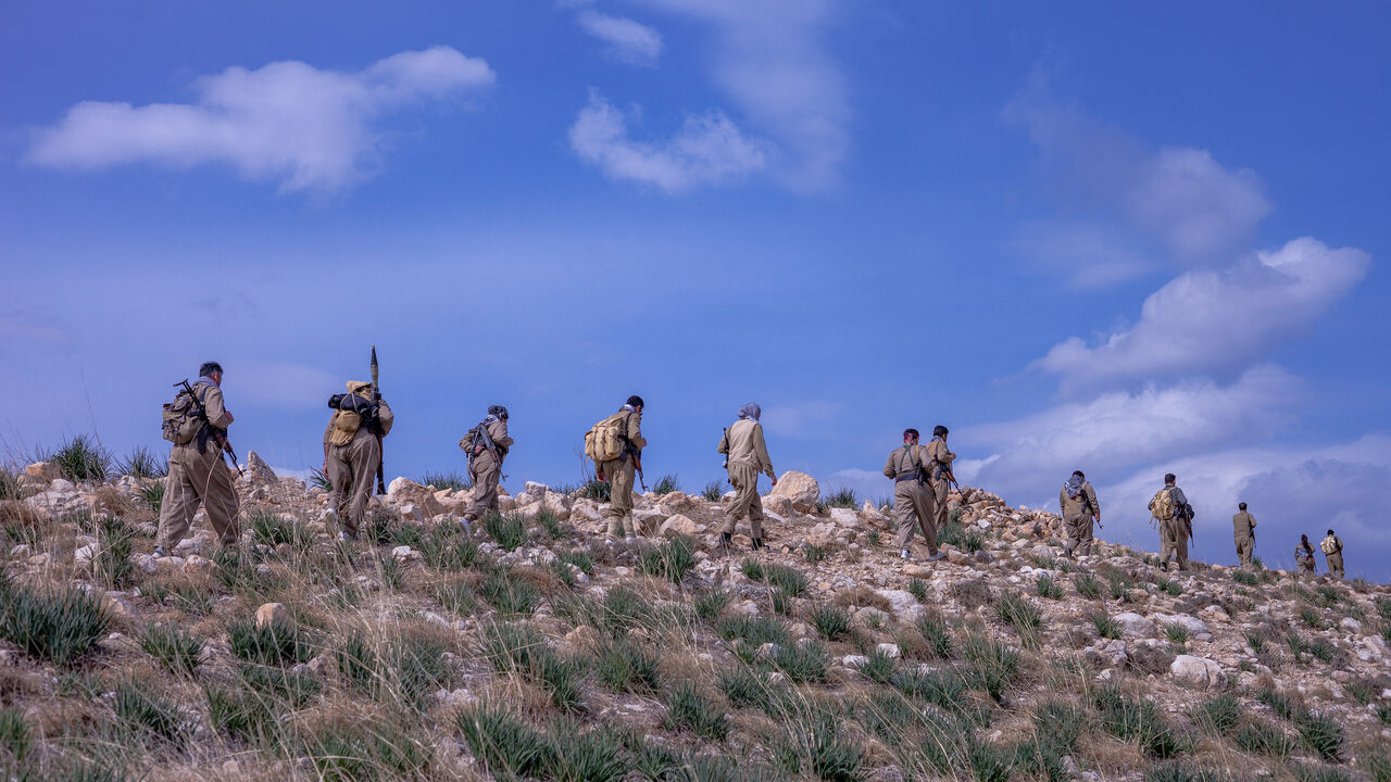 A group of Peshmergas of the Democratic Party of Iranian Kurdistan (PDKI) walks during military training near one of their bases in the Kurdistan Region of Iraq, on March 1, 2025. 