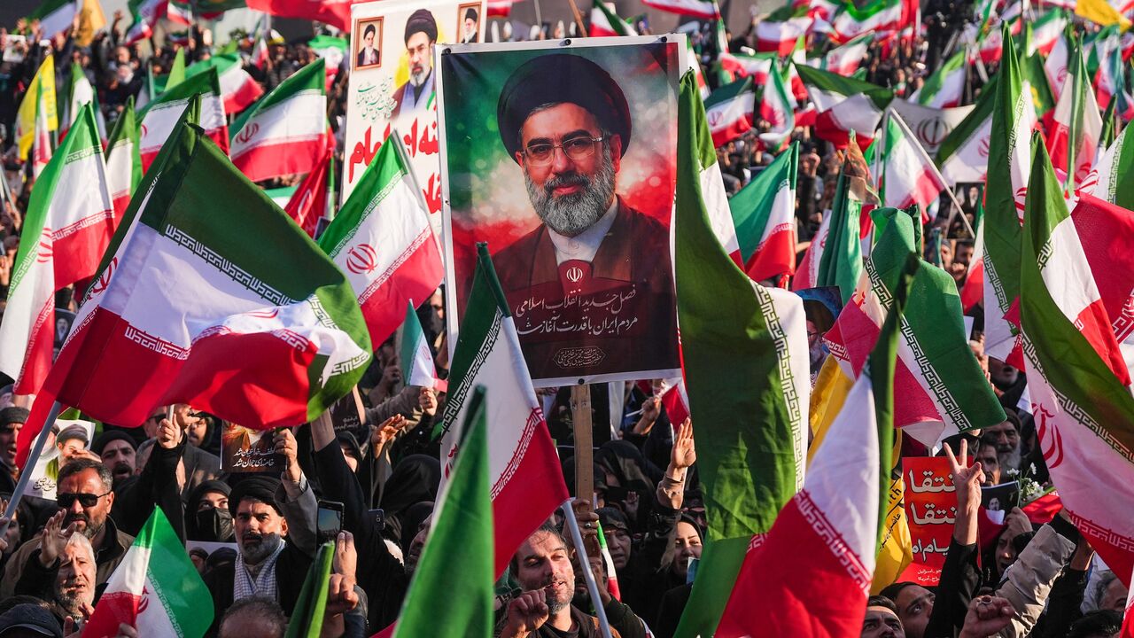 A demonstrator holds a picture of Iran's new supreme leader, Ayatollah Mojtaba Khamenei, at Enghelab Square in central Tehran on March 9, 2026.