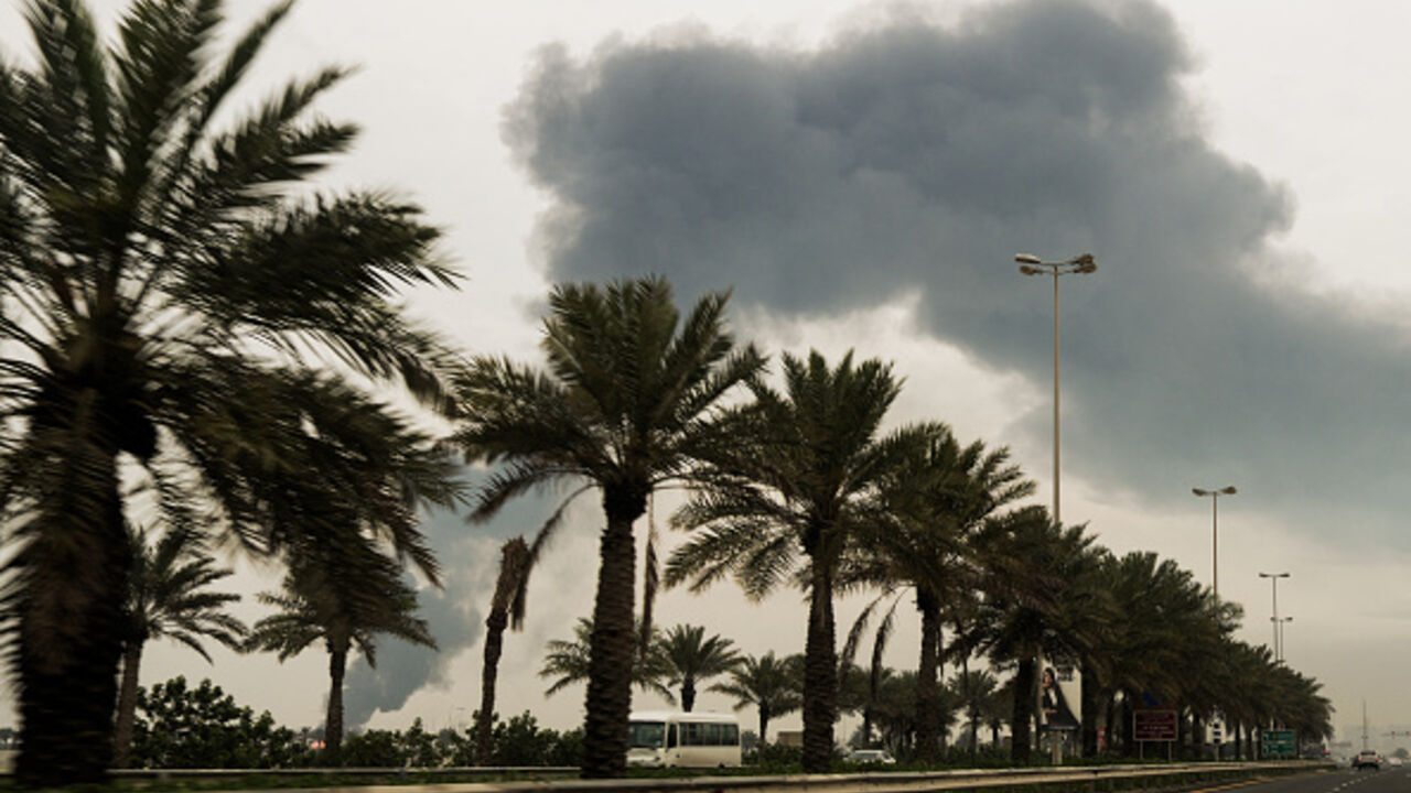 A plume of smoke rises after a reported Iranian strike on fuel tanks in Muharraq on March 12, 2026. (Fadhel MADHAN / AFP via Getty Images)