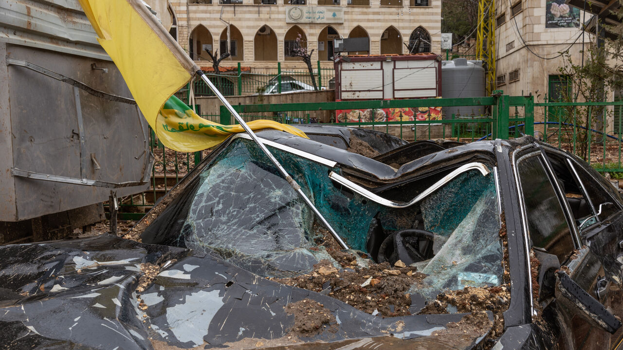 A Hezbollah flag is seen in a destroyed car after an Israeli airstrike in Nabi Chit (Al-Nabi Shayth), Lebanon, on March 26, 2026. In the first week of March, the Israeli army carried out an unsuccessful nighttime commando operation there to recover the remains of Ron Arad, a pilot missing since 1986, triggering airstrikes and destruction in the area that forced residents to flee their homes. (Photo by Fabio Bucciarelli / Middle East Images / AFP via Getty Images)