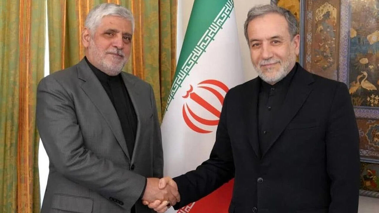 Iran’s ambassador to Beirut, Mohammad Reza Sheibani (L), shakes hands with Iranian Foreign Minister Abbas Araghchi in an undated photo. 
