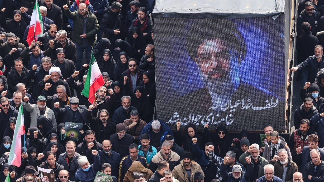 A screen displays a portrait of Iran's new supreme leader Mojtaba Khamenei during the funerals of Iran's Revolutionary Guards Corps (IRGC) commanders, army commanders and others killed in the early days of the United States and Israeli strikes on Iran, at Enghelab Square in Tehran on March 11, 2026