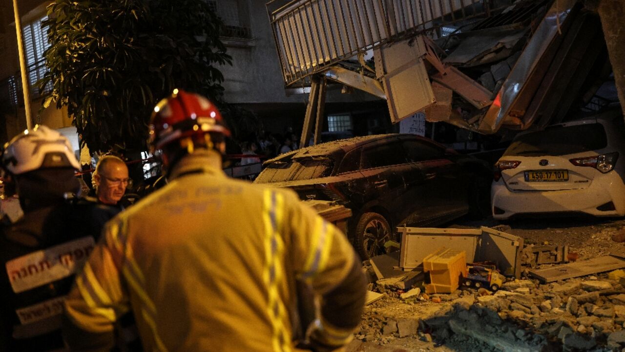 Buildings were damaged and more than 12 people injured following multiple rounds of Iranian missile fire on Israel