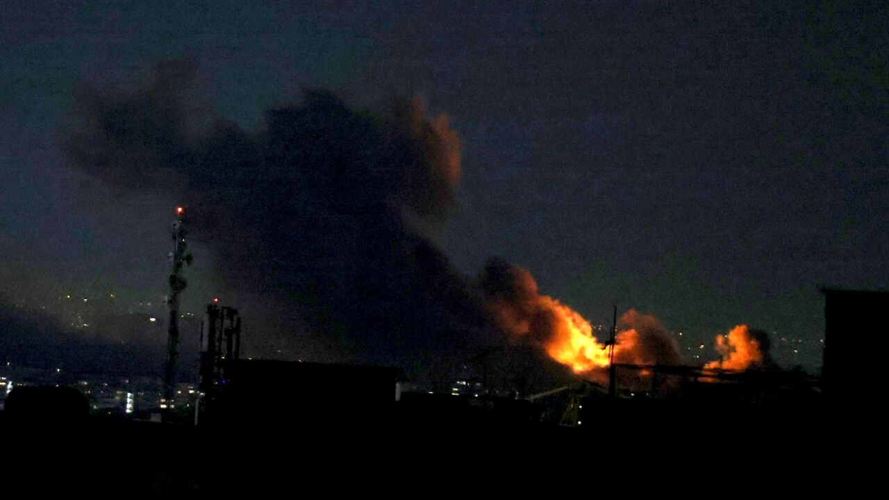 A plume of smoke rises from the site of a strike in Tehran on Monday